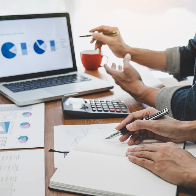 Financial professionals analyzing data charts and reports — accounting and finance recruitment services.