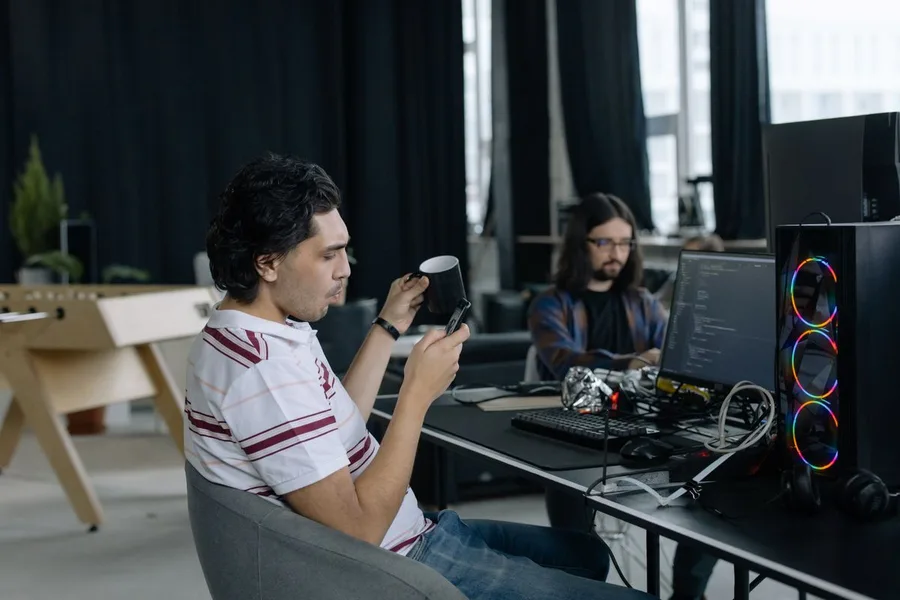 Software developers coding together in a modern office