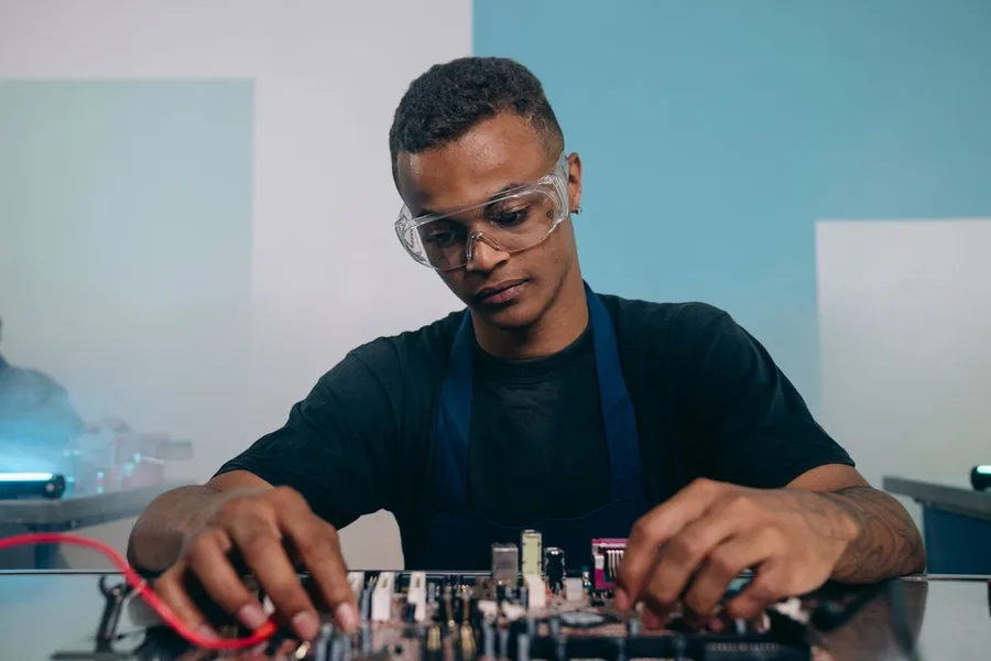 Electronics engineer assembling a circuit board